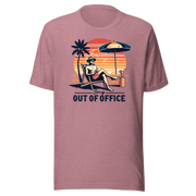 Man lounging in a beach chair with a cocktail, wearing our 'Sorry, Out of Office' vintage tee against a retro sunset backdrop.