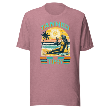 Vintage-inspired 'Tanned and Tipsy' tee with a woman sipping a cocktail on a beach at sunset, perfect for beach drinking and summer parties.