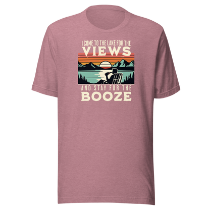 Tee showing "I Come to the Lake for the Views and Stay for the Booze," with a man in a beach chair, lake, and retro sunset.