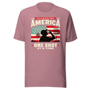 T-shirt with Celebrating America One Shot at a Time text, silhouette of a man drinking a shot, and distressed American flag background. Perfect for 4th of July.