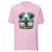 Woman with cocktail on beach on 'Sun, Sand, and a Drink in My Hand' tee, showcasing ocean and sun background