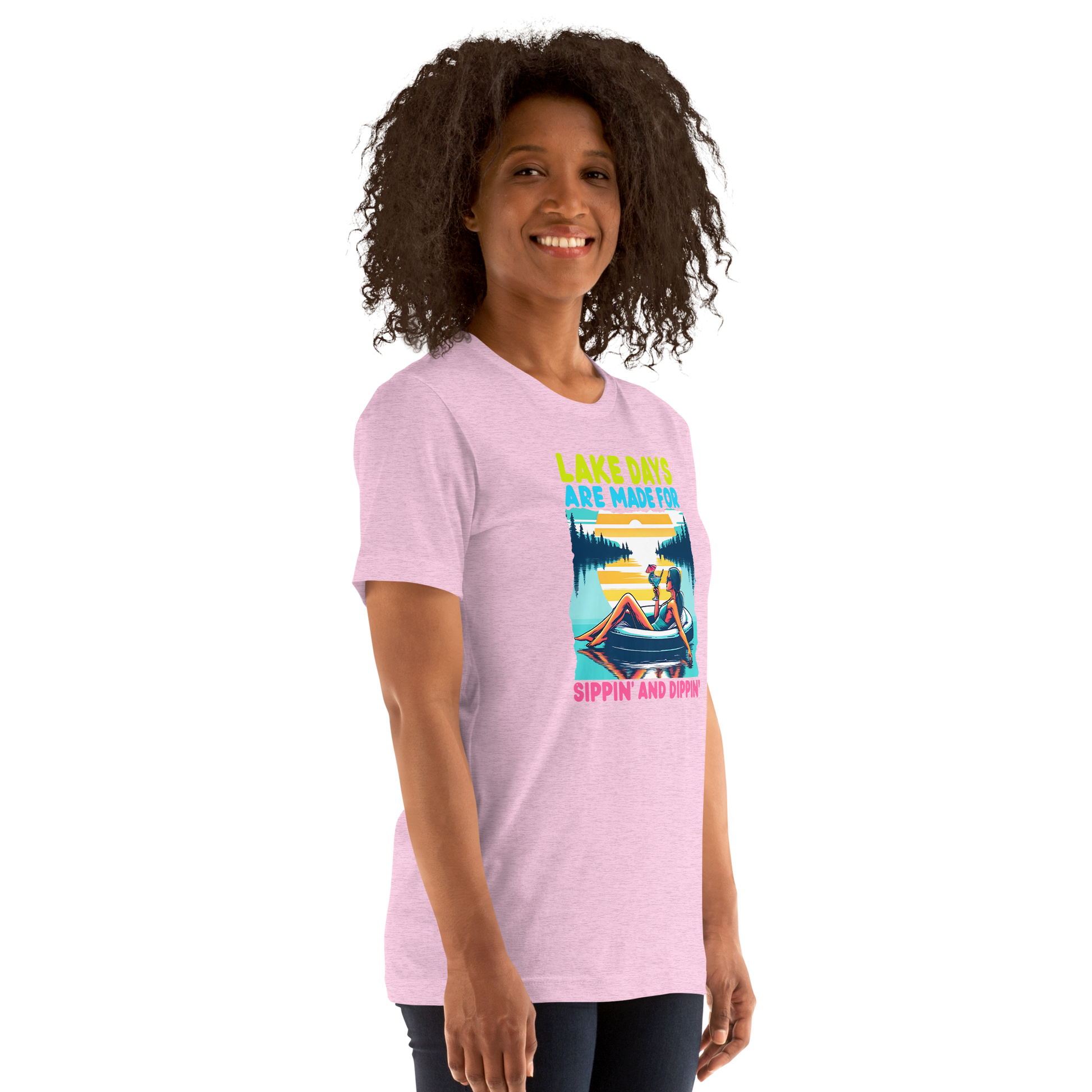 Tee with "Lake Days Are Made for Sipping and Dipping," featuring a woman on a tube float with a cocktail, lake and sunset backdrop.