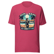 Woman with cocktail on beach on 'Sun, Sand, and a Drink in My Hand' tee, showcasing ocean and sun background