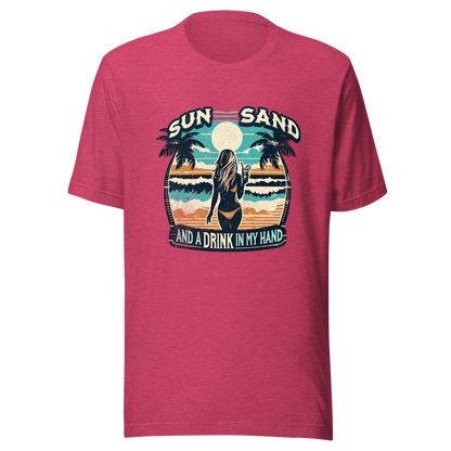 Woman with cocktail on beach on 'Sun, Sand, and a Drink in My Hand' tee, showcasing ocean and sun background