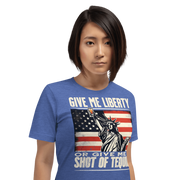 T-shirt with Give Me Liberty or Give Me a Shot of Tequila text, Statue of Liberty holding a shot glass, and distressed American flag background. Perfect for 4th of July.