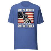 T-shirt with Give Me Liberty or Give Me a Shot of Tequila text, Statue of Liberty holding a shot glass, and distressed American flag background. Perfect for 4th of July.