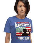 T-shirt with Celebrating America One Shot at a Time text, silhouette of a man drinking a shot, and distressed American flag background. Perfect for 4th of July.