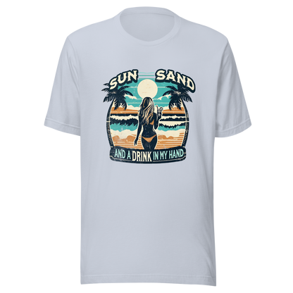 Woman with cocktail on beach on 'Sun, Sand, and a Drink in My Hand' tee, showcasing ocean and sun background