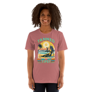 Vintage-inspired 'Tanned and Tipsy' tee with a woman sipping a cocktail on a beach at sunset, perfect for beach drinking and summer parties.