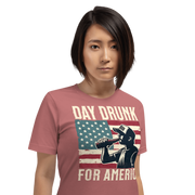 T-shirt with Day Drunk for America text, silhouette of a man drinking a bottle of beer, and distressed American flag background. Perfect for 4th of July.