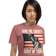 T-shirt with Give Me Liberty or Give Me a Shot of Tequila text, Statue of Liberty holding a shot glass, and distressed American flag background. Perfect for 4th of July.