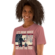 4th of July T-shirt with 'Let's Drink Booze and Light the Fuse' text, featuring a festive, patriotic theme