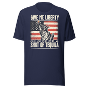 T-shirt with Give Me Liberty or Give Me a Shot of Tequila text, Statue of Liberty holding a shot glass, and distressed American flag background. Perfect for 4th of July.