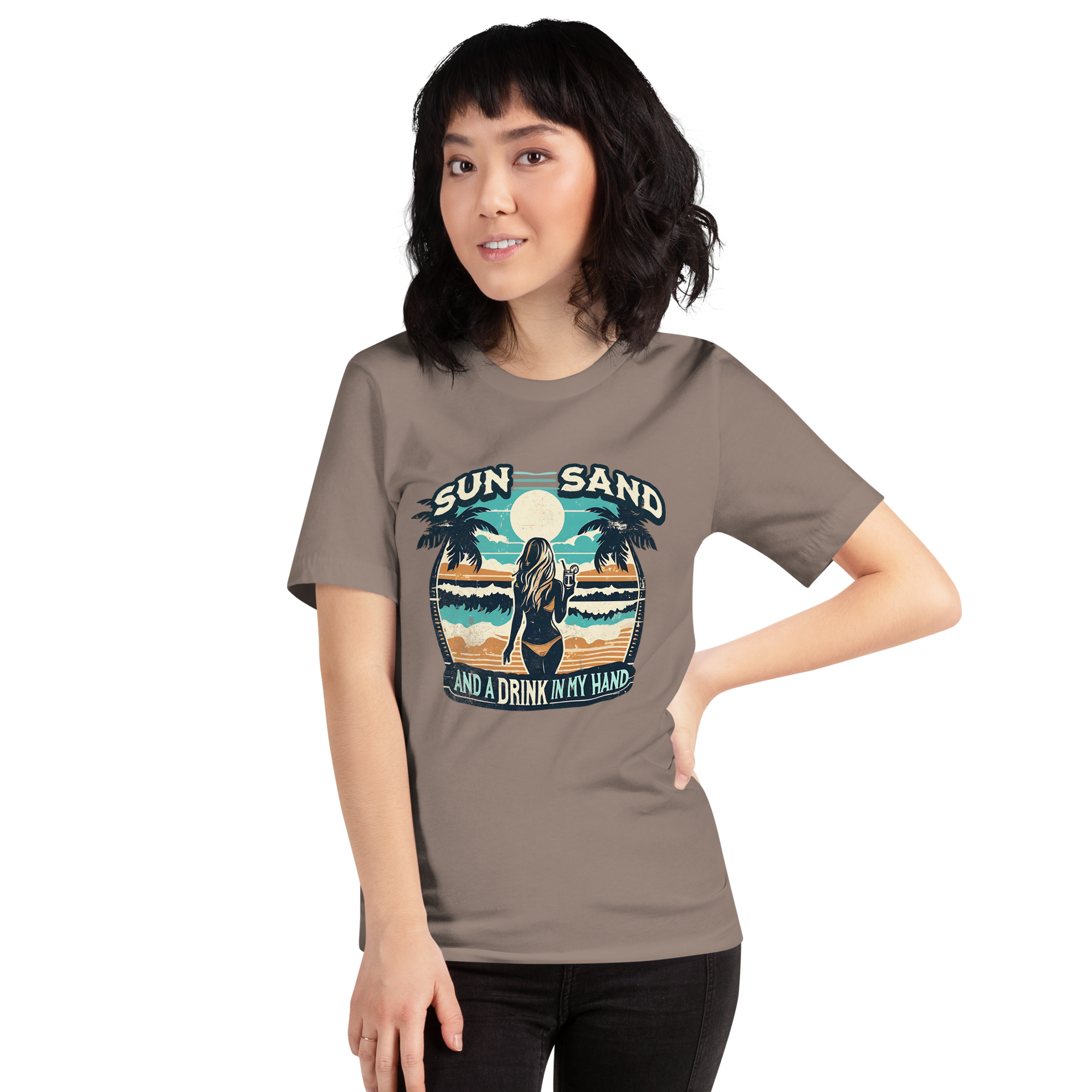 Woman with cocktail on beach on 'Sun, Sand, and a Drink in My Hand' tee, showcasing ocean and sun background