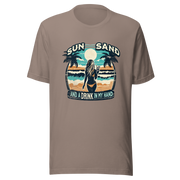 Woman with cocktail on beach on 'Sun, Sand, and a Drink in My Hand' tee, showcasing ocean and sun background