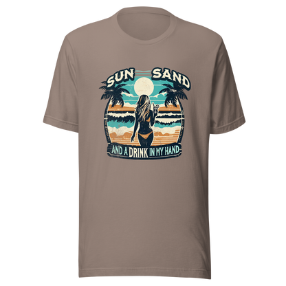 Woman with cocktail on beach on 'Sun, Sand, and a Drink in My Hand' tee, showcasing ocean and sun background