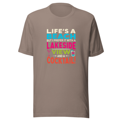 Tee displaying "Life's a Beach but I Prefer It with a Lakeside View and a Cocktail" in bright, eye-catching colors.