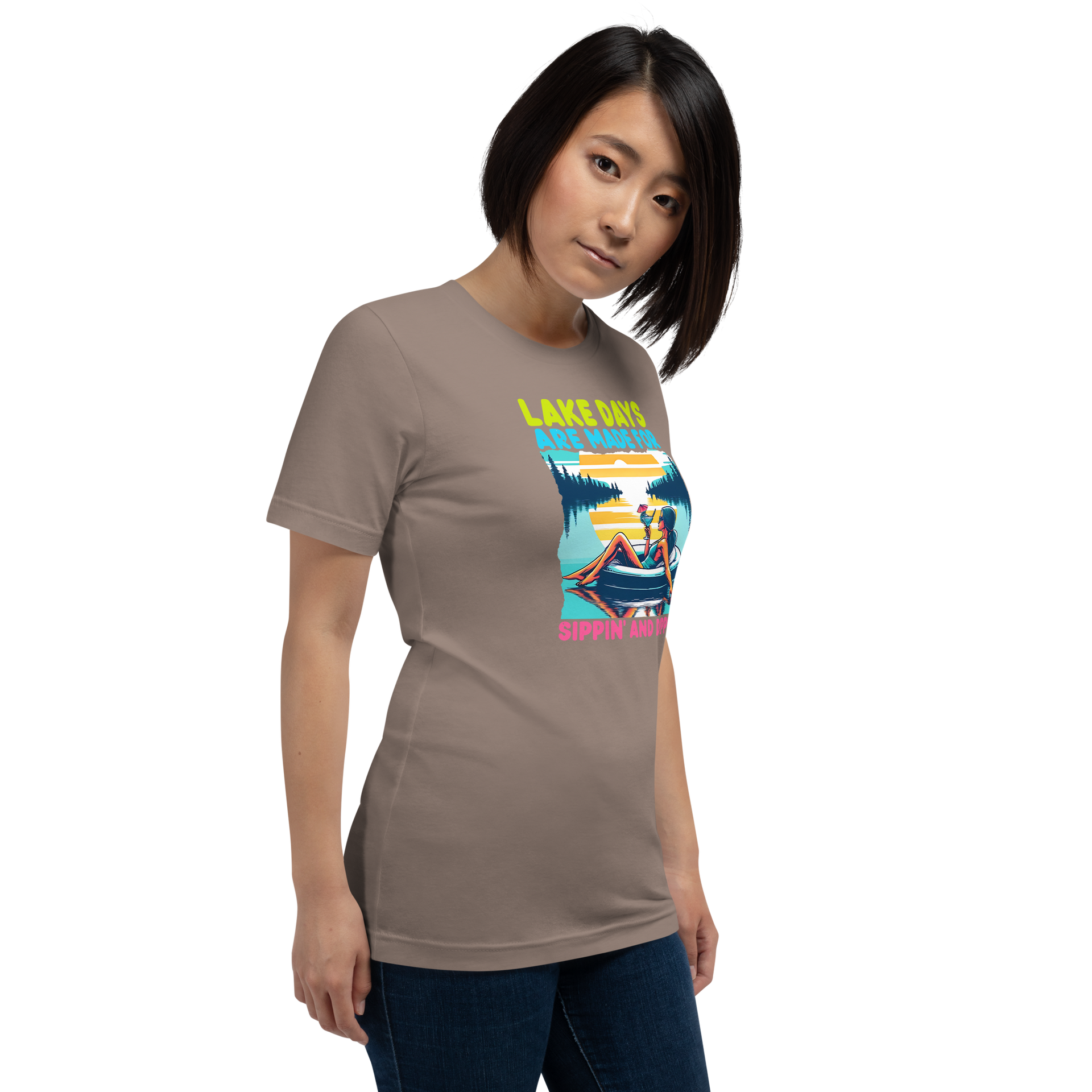 Tee with "Lake Days Are Made for Sipping and Dipping," featuring a woman on a tube float with a cocktail, lake and sunset backdrop.