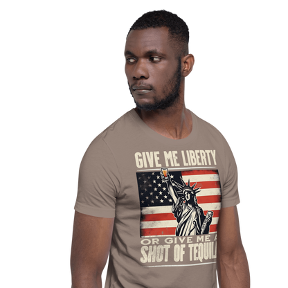 T-shirt with Give Me Liberty or Give Me a Shot of Tequila text, Statue of Liberty holding a shot glass, and distressed American flag background. Perfect for 4th of July.