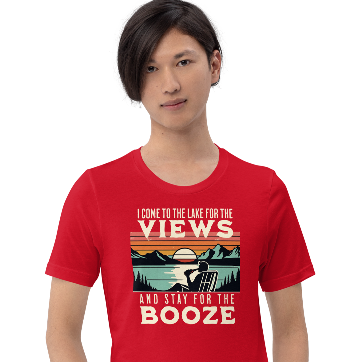 Tee showing "I Come to the Lake for the Views and Stay for the Booze," with a man in a beach chair, lake, and retro sunset.