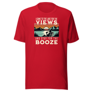 Tee showing "I Come to the Lake for the Views and Stay for the Booze," with a man in a beach chair, lake, and retro sunset.