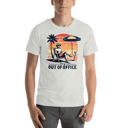 Man lounging in a beach chair with a cocktail, wearing our 'Sorry, Out of Office' vintage tee against a retro sunset backdrop.
