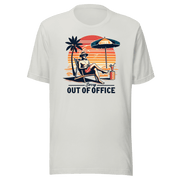 Man lounging in a beach chair with a cocktail, wearing our 'Sorry, Out of Office' vintage tee against a retro sunset backdrop.