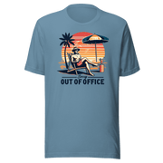 Man lounging in a beach chair with a cocktail, wearing our 'Sorry, Out of Office' vintage tee against a retro sunset backdrop.