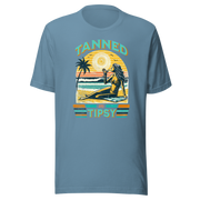 Vintage-inspired 'Tanned and Tipsy' tee with a woman sipping a cocktail on a beach at sunset, perfect for beach drinking and summer parties.