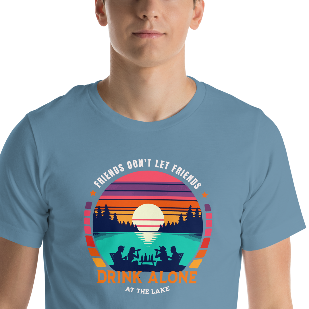 Tee showcasing "Friends Don't Let Friends Drink Alone at the Lake" with a retro sunset and lake scene.