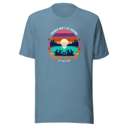 Tee showcasing "Friends Don't Let Friends Drink Alone at the Lake" with a retro sunset and lake scene.