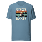 Tee showing "I Come to the Lake for the Views and Stay for the Booze," with a man in a beach chair, lake, and retro sunset.