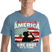 T-shirt with Celebrating America One Shot at a Time text, silhouette of a man drinking a shot, and distressed American flag background. Perfect for 4th of July.