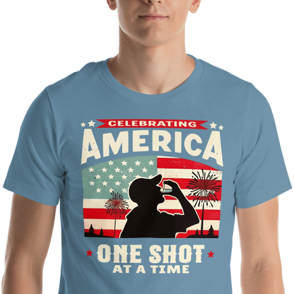 T-shirt with Celebrating America One Shot at a Time text, silhouette of a man drinking a shot, and distressed American flag background. Perfect for 4th of July.