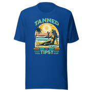 Vintage-inspired 'Tanned and Tipsy' tee with a woman sipping a cocktail on a beach at sunset, perfect for beach drinking and summer parties.