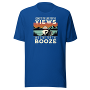 Tee showing "I Come to the Lake for the Views and Stay for the Booze," with a man in a beach chair, lake, and retro sunset.