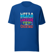 Tee displaying "Life's a Beach but I Prefer It with a Lakeside View and a Cocktail" in bright, eye-catching colors.