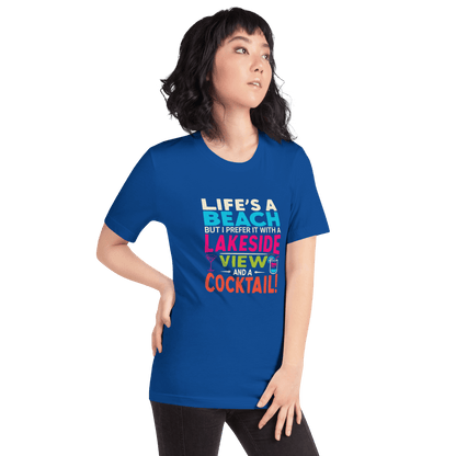 Tee displaying "Life's a Beach but I Prefer It with a Lakeside View and a Cocktail" in bright, eye-catching colors.