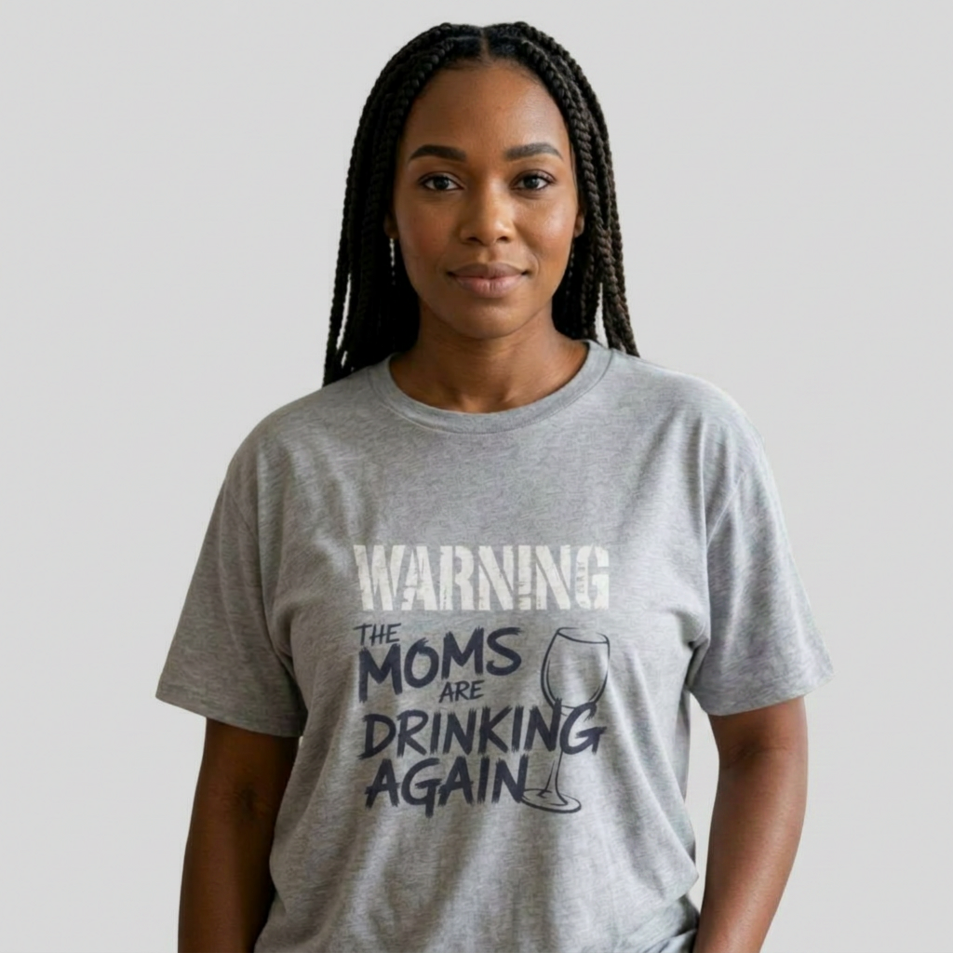Woman wearing a gray t-shirt with the text 'Warning:the moms are drinking again' funny mother's day, beach trip, girls trip design