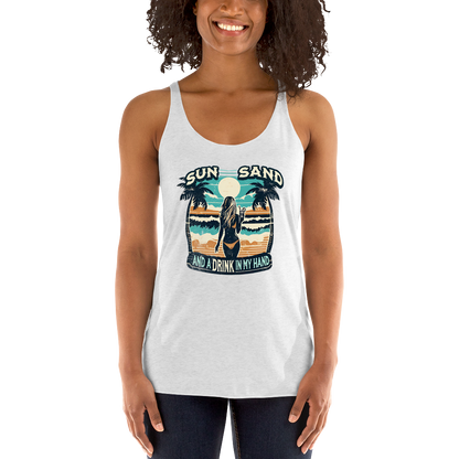 Beach scene on 'Sun, Sand, and a Drink in My Hand' racerback tank, with woman holding cocktail.