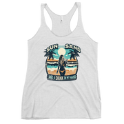 Beach scene on 'Sun, Sand, and a Drink in My Hand' racerback tank, with woman holding cocktail.