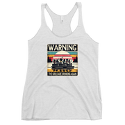 Racerback tank featuring "Warning: The Girls Are Drinking Again" with an illustration of girls drinking on a pontoon boat at sunset.