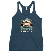 Racerback tank featuring "It's a Good Day to Drink at the Lake with Friends," with people on a boat, lake, and mountains in the background.