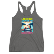 Racerback tank with "Lake Days Are Made for Sipping and Dipping," featuring a woman on a tube float with a cocktail, against a lake and sunset.