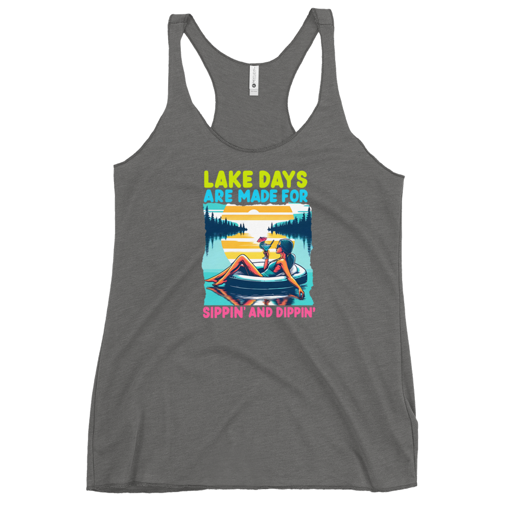 Racerback tank with "Lake Days Are Made for Sipping and Dipping," featuring a woman on a tube float with a cocktail, against a lake and sunset.