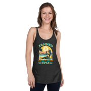 Retro 'Tanned and Tipsy' racerback tank with a woman enjoying a sunset cocktail on the beach, ideal for summer beach parties and day drinking.