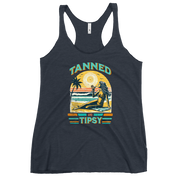 Retro 'Tanned and Tipsy' racerback tank with a woman enjoying a sunset cocktail on the beach, ideal for summer beach parties and day drinking.