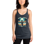 Beach scene on 'Sun, Sand, and a Drink in My Hand' racerback tank, with woman holding cocktail.