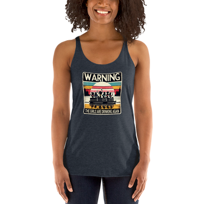 Racerback tank featuring "Warning: The Girls Are Drinking Again" with an illustration of girls drinking on a pontoon boat at sunset.