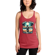 Beach scene on 'Sun, Sand, and a Drink in My Hand' racerback tank, with woman holding cocktail.